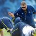Michigan head coach Brady Hoke looks to pat a play as he stretches during warm ups on the practice field outside of the Al Glick Field House on Thursday, August 8, 2013. Melanie Maxwell | AnnArbor.com 